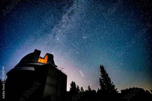 Milky way galaxy over observatory photo