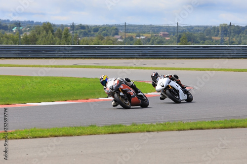 Two riders on motorcycles riding on the race track