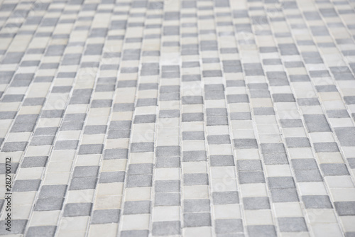 the ground of white and grey tiles