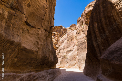 The stone walls of the narrow passage  Siq  that leads to Petra in Jordan