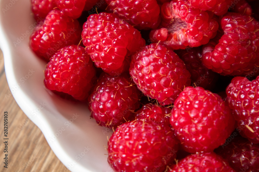 Fresh raw organic raspberries on a plate Fresh raw organic raspberries on a plate