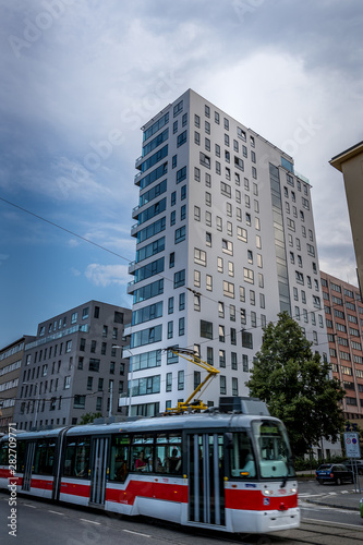 High-rise panel house with glass windows and balconies in the center of Brno Czech Republic and captured during the transit of the public transport tram