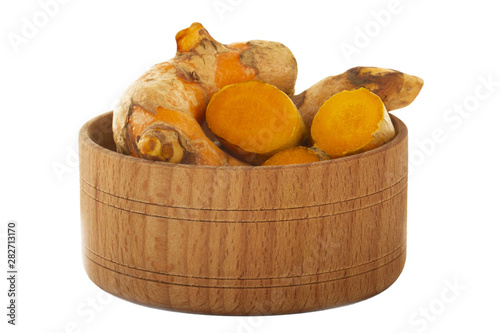 heap of turmeric in wooden cup isolated on white background photo