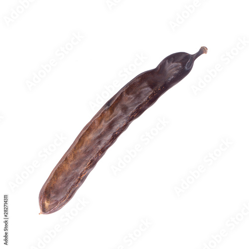 dried long carob pod isolated on white background