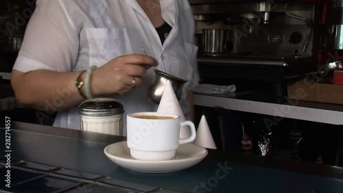 Serving cafe con leche coffee on Calle Ocho Miami home of Cuban American immigrant population