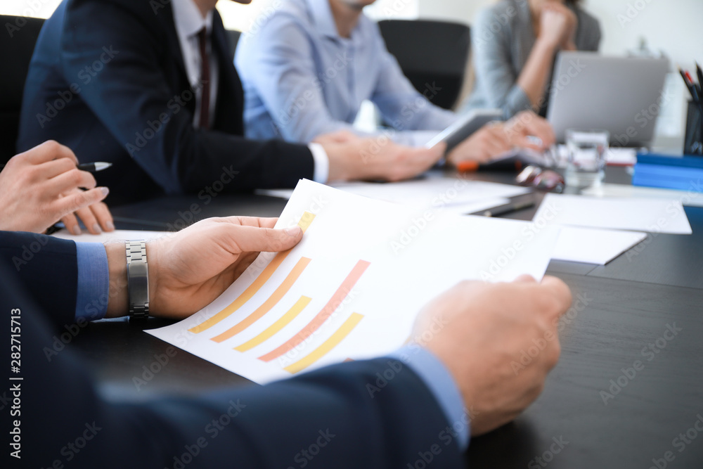 Businessman with document during meeting in office, closeup Businessman with document during meeting in office, closeup
