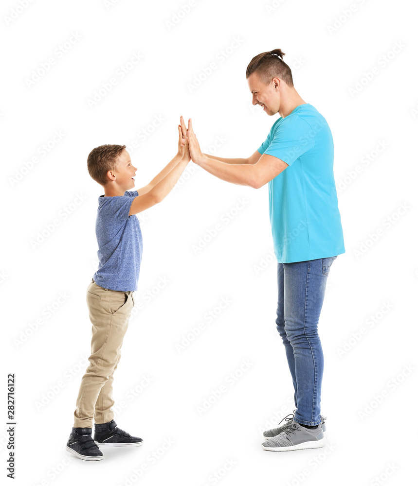 Portrait of father and son giving each other high-five on white background Portrait of father and son giving each other high-five on white background