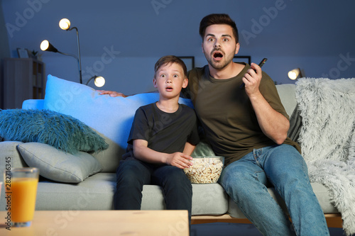 Father with son watching sc...