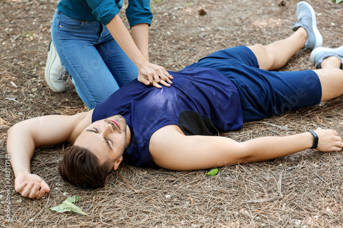 Woman giving CPR to unconsc...