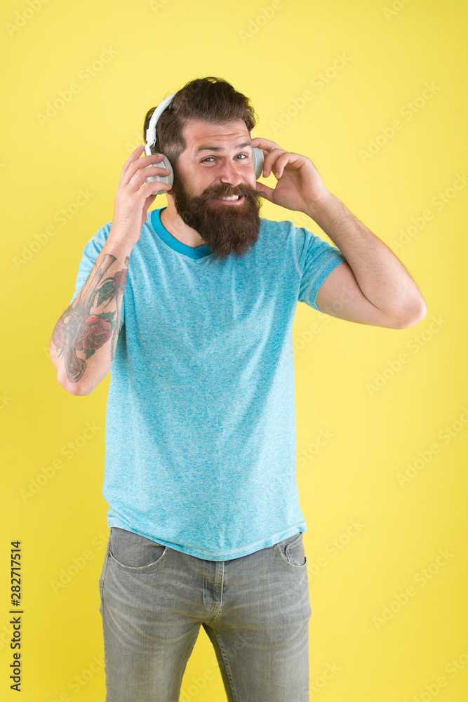 Freedom going wireless offers you is unparalleled. Hipster happy using modern wireless headphones. Wireless headphones designed to deliver clean sound. Bearded man listening music wireless gadget Freedom going wireless offers you is unparalleled. Hipster happy using modern wireless headphones. Wireless headphones designed to deliver clean sound. Bearded man listening music wireless gadget