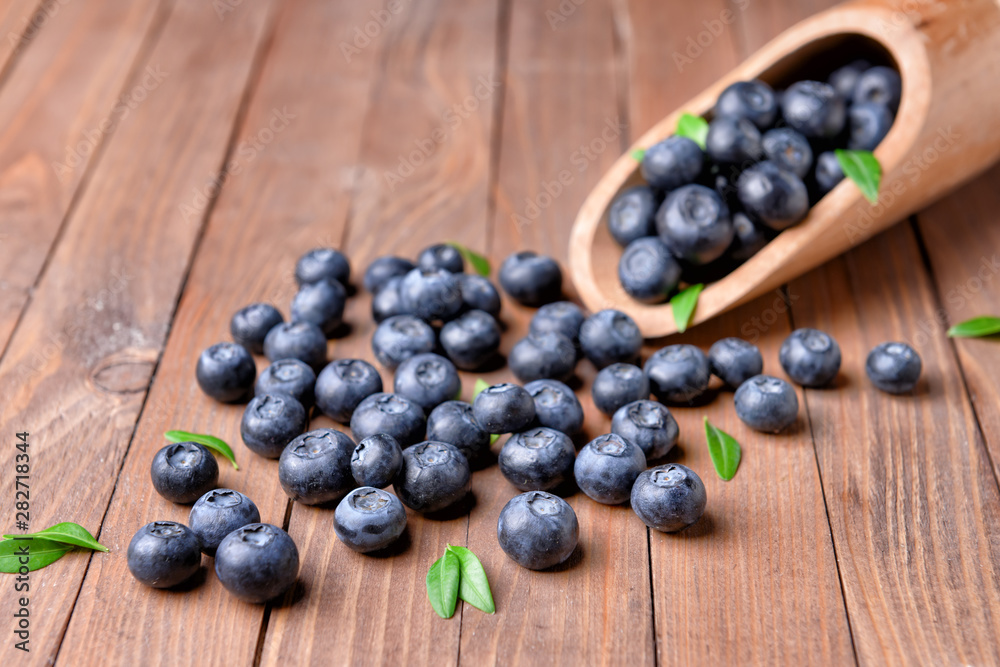 Scoop with ripe blueberry on wooden background Scoop with ripe blueberry on wooden background