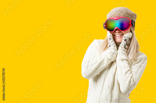 Woman Skier Standing at Snow Looking . Winter yellow, orange, background © Angelov