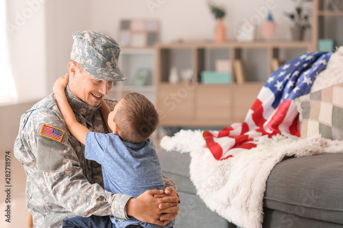 Happy military man with his son at home