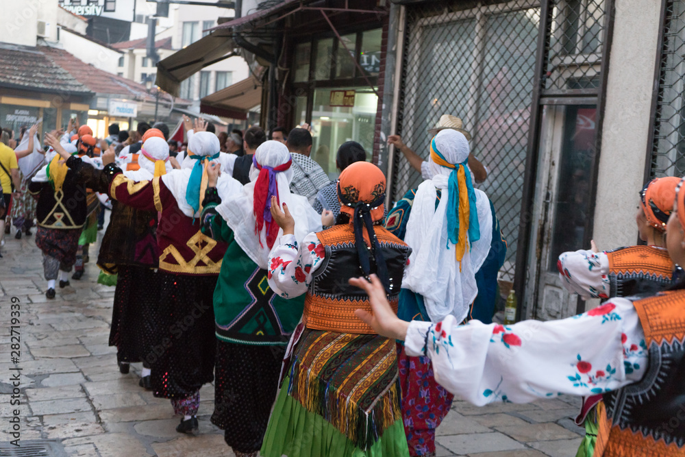 Skopje / Macedonia - July 06 2019: International parade in the streets of Skopje, Macedonia with traditional costume folk dress ready to dance in the festival. Group of folklore people