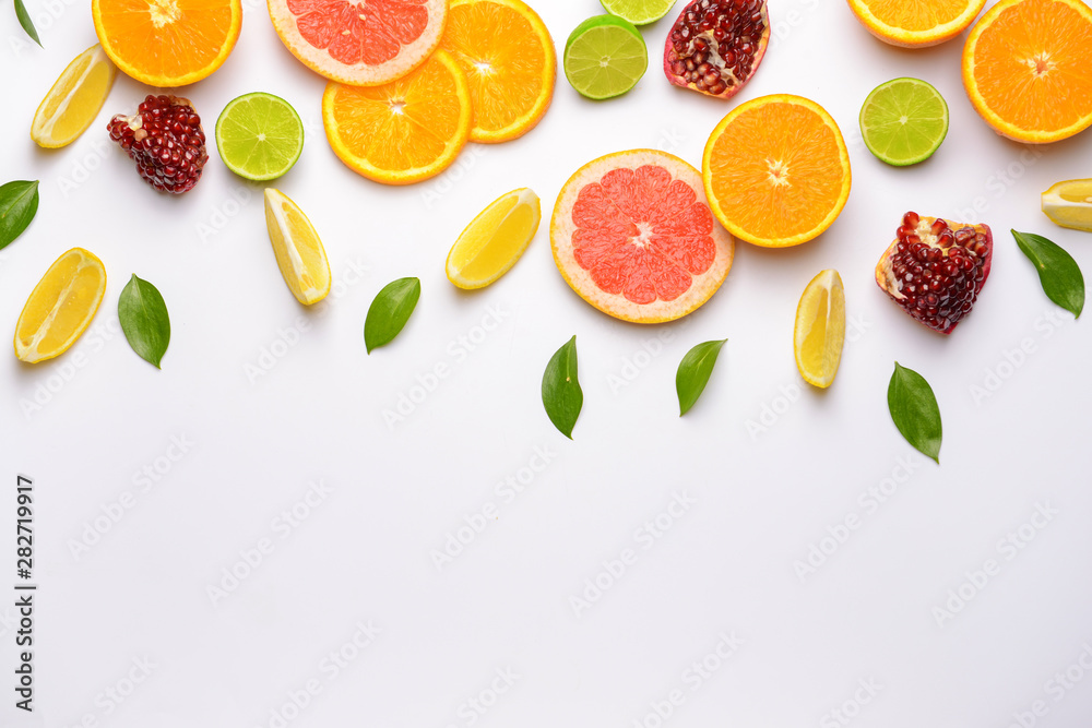 Naklejka Different sliced citrus fruits on white background