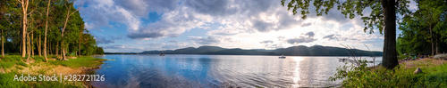 Panoramic view of a lake at sunset in summer.