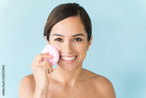 Beautiful Female With Bare Shoulders Taking Skincare Over Blue Background