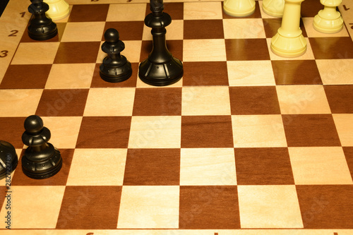 Chechered board under white pieces as a leisure concept