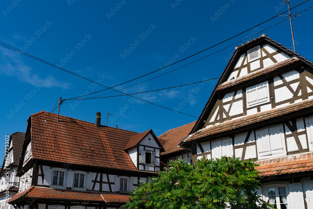 white half timbered house with shutters and orange roof tiles. Hunspach, France white half timbered house with shutters and orange roof tiles. Hunspach, France