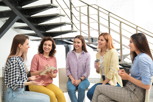 Cheerful ladies at meeting indoors. Women power concept photo