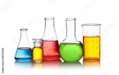 Set of lab glassware with color liquids isolated on white. Solution chemistry