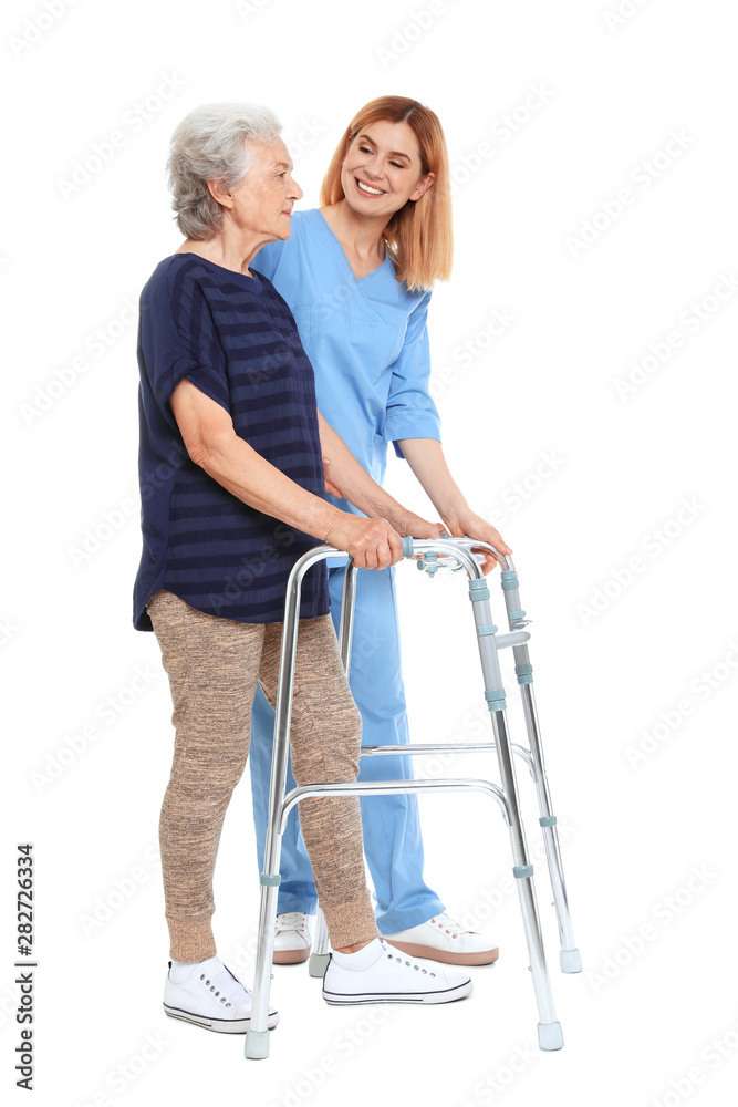 Caretaker helping elderly woman with walking frame on white background Caretaker helping elderly woman with walking frame on white background