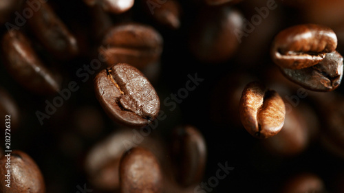 Coffee beans flying in the air, macro photo
