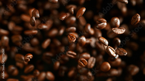 Coffee beans flying in the air  macro photo