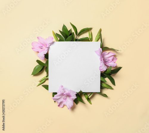 Fototapeta Naklejka Na Ścianę i Meble -  Beautiful gladiolus flowers and blank card on yellow background, flat lay. Space for text