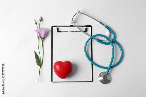 Composition with stethoscope and flower on white background. World health day © New Africa