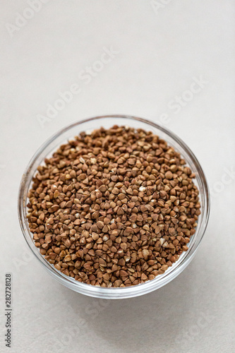 Bowl of buckwheat isolated on white background. Top view.