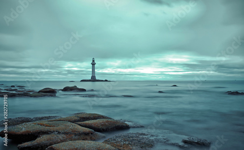 calm ocean stones and lighthouse