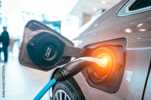 Power supply plugged into an electric car being charged.