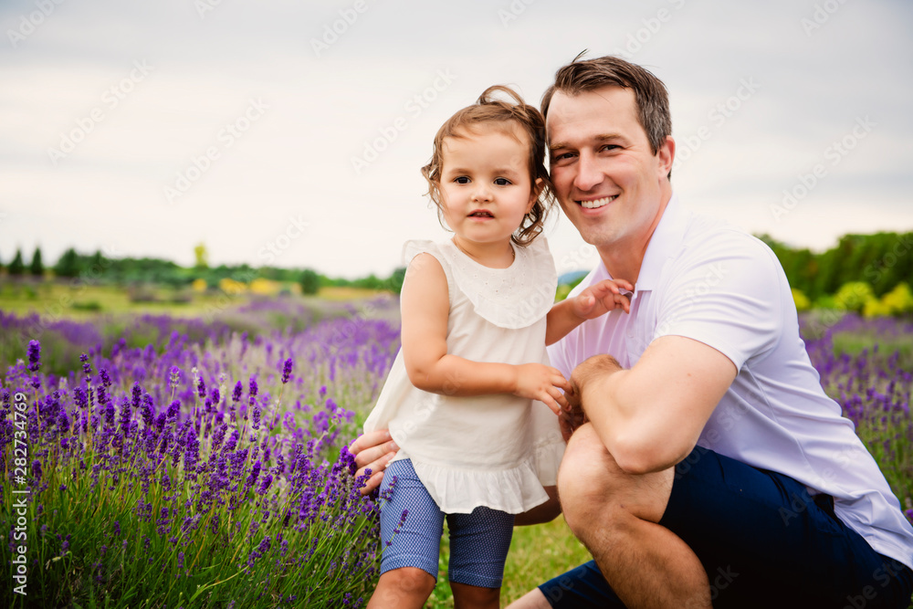 Happy family father and daughter having fun in lavender field Happy family father and daughter having fun in lavender field