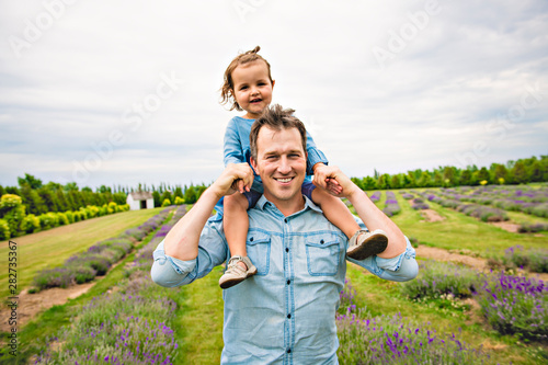 Happy family father and daughter having fun in lavender field