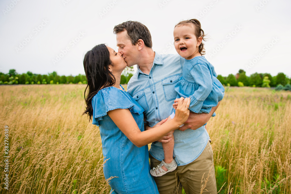 Portrait of a happy young family in the countryside Portrait of a happy young family in the countryside