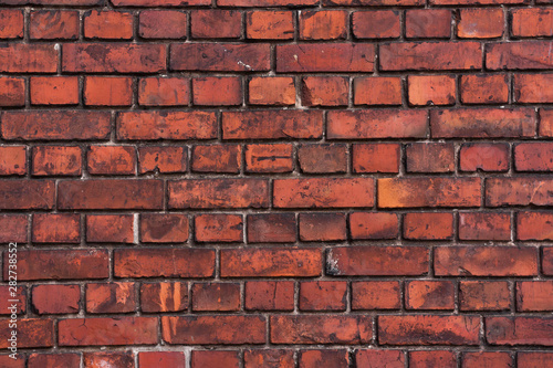 Red bright brick wall background. Small tiles. Textured wallpaper.