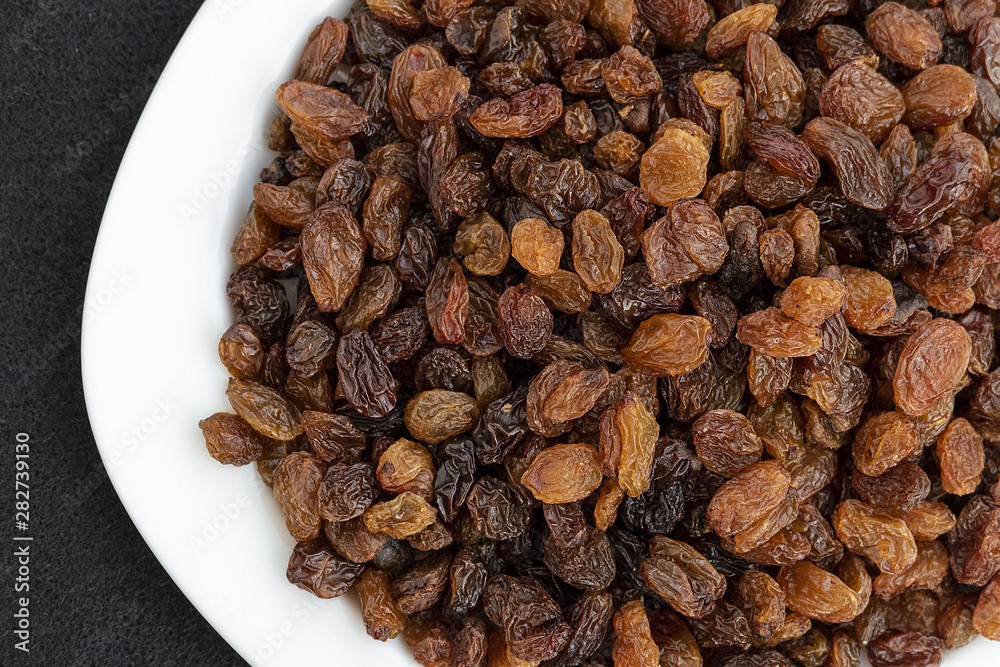 yellow seedless raisins on a plate, close-up yellow seedless raisins on a plate, close-up