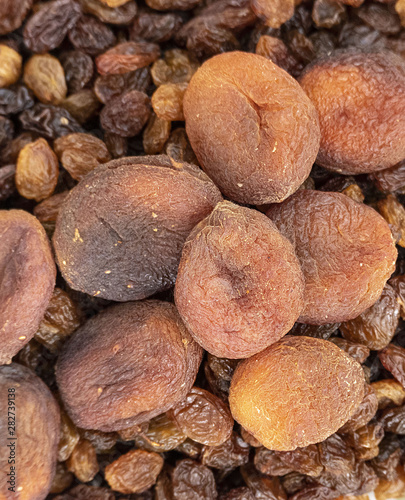 close-up of yellow seedless raisins and day dried apricots, on a plate