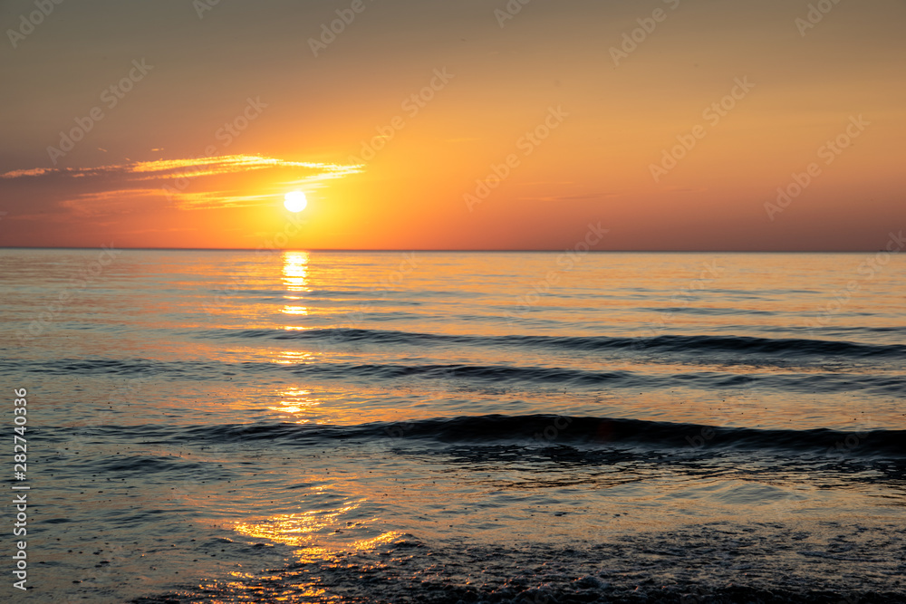 Sunset on the sea beach, beautiful view sunset, evening at the beach by the sea