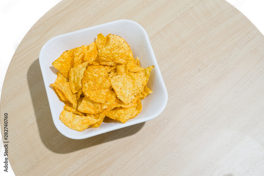 The Corn chip on wooden table and white background The Corn chip on wooden table and white background