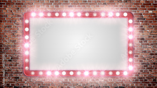 A blank marquee sign on a red brick wall with flashing lights.	