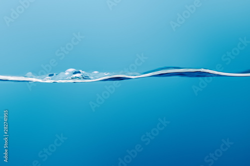 transparent pure calm water on blue background