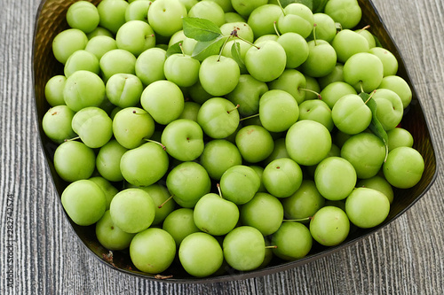 close-up of green sour plums, fresh green plums,