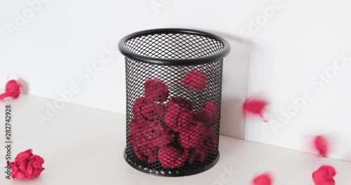 Throw papers into plastic trash can