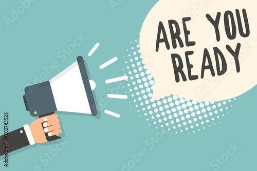 Handwriting text Are You Ready. Concept meaning Alertness Preparedness Urgency Game Start Hurry Wide awake Man holding megaphone loudspeaker speech bubble blue background halftone