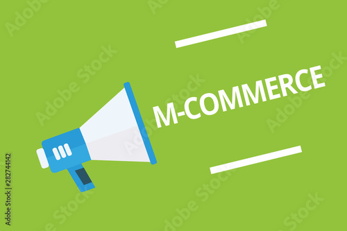 Handwriting text writing M Commerce. Concept meaning commercial transactions conducted electronically by mobile phone Megaphone loudspeaker green background important message speaking loud photo