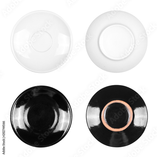 Set of white and black saucers on an isolated white background
