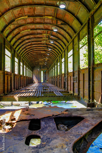 An old railroad car has been used as a bridge over a creek outside Kutasi, Georgia, but has now been left to crumble photo