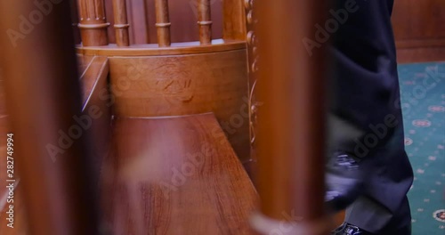 Close up of black male legs. A businessman climbs the wooden steps and walks to the window. Luxury apartments, meditations, a blue suit, business style, fashion, patent leather shoes. photo